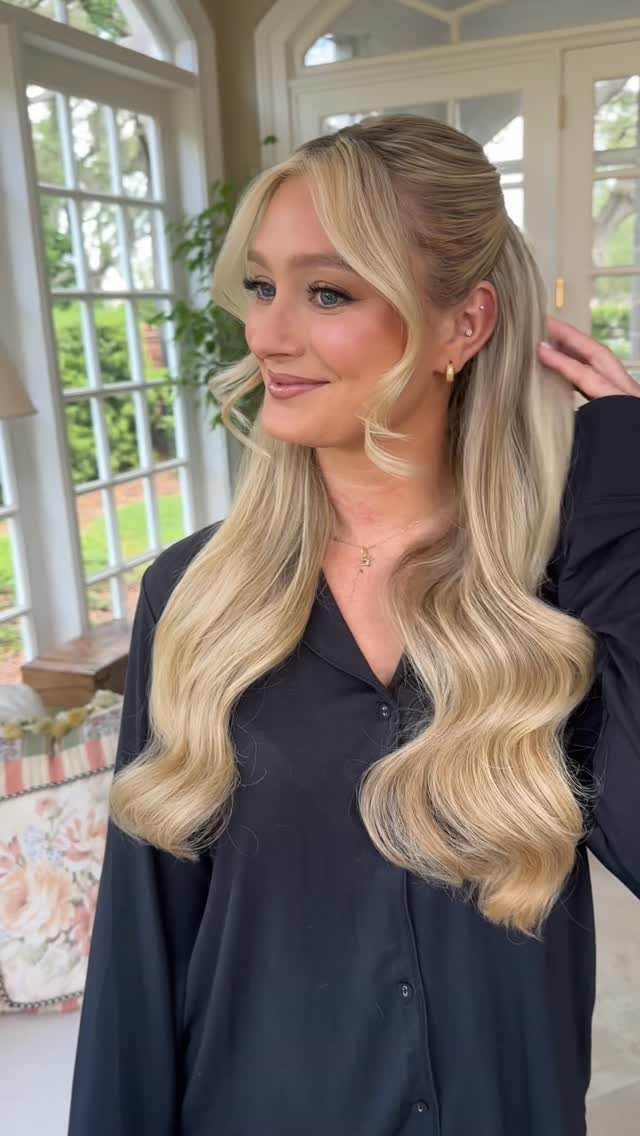 9 Cute Hair Styles for Church, From Buns to Box Braids 5 Woman with blonde wavy hair in a half-up hairstyle wearing a black shirt.