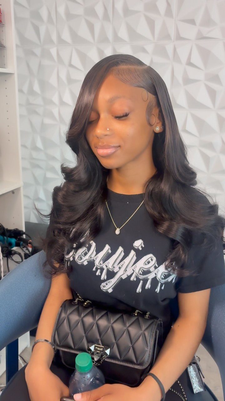 16 Cute Hairstyles for a Birthday Party, Waves to Braids 8 Woman with long dark hair styled in voluminous side swept curls and a side part.