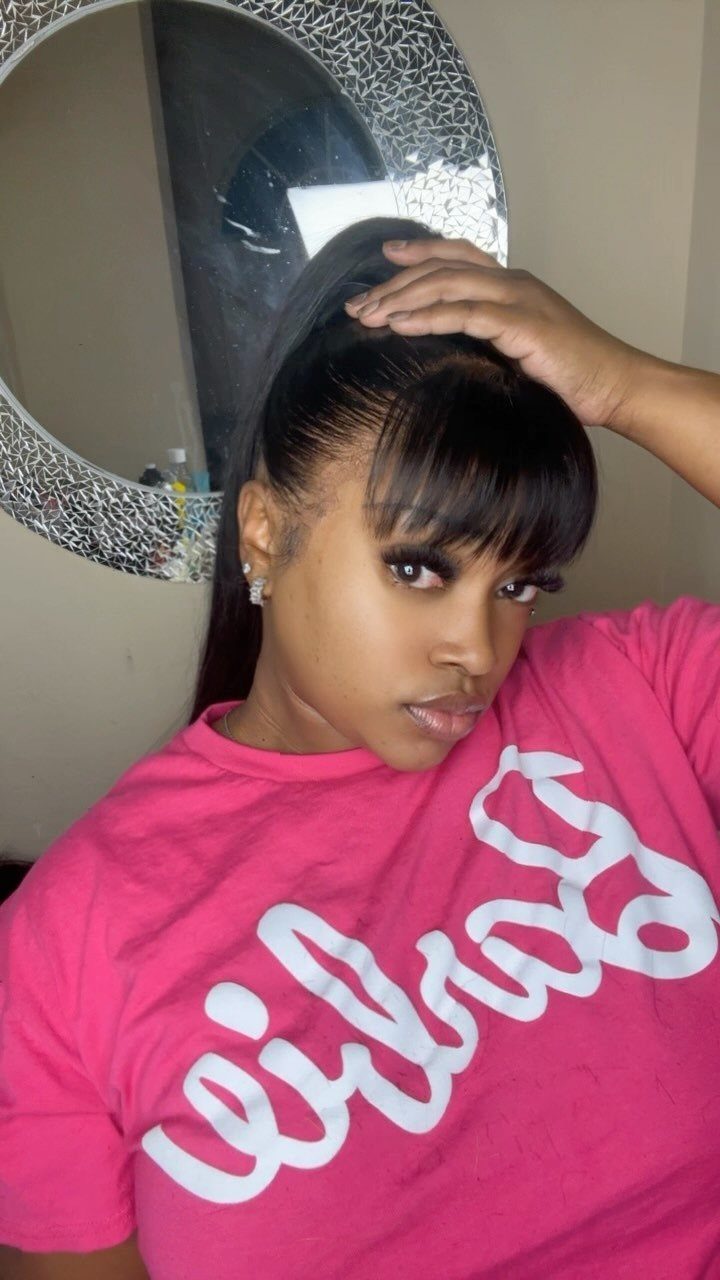 16 Cute Hairstyles for a Birthday Party, Waves to Braids 6 Woman with a sleek high ponytail and blunt bangs wearing a pink t-shirt.