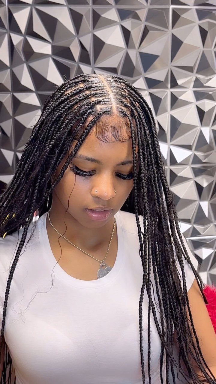 Cute Hairstyles for Hot Days: 11 Easy Ideas to Try 10 Woman with long black box braids wearing a white t-shirt and gold necklace.