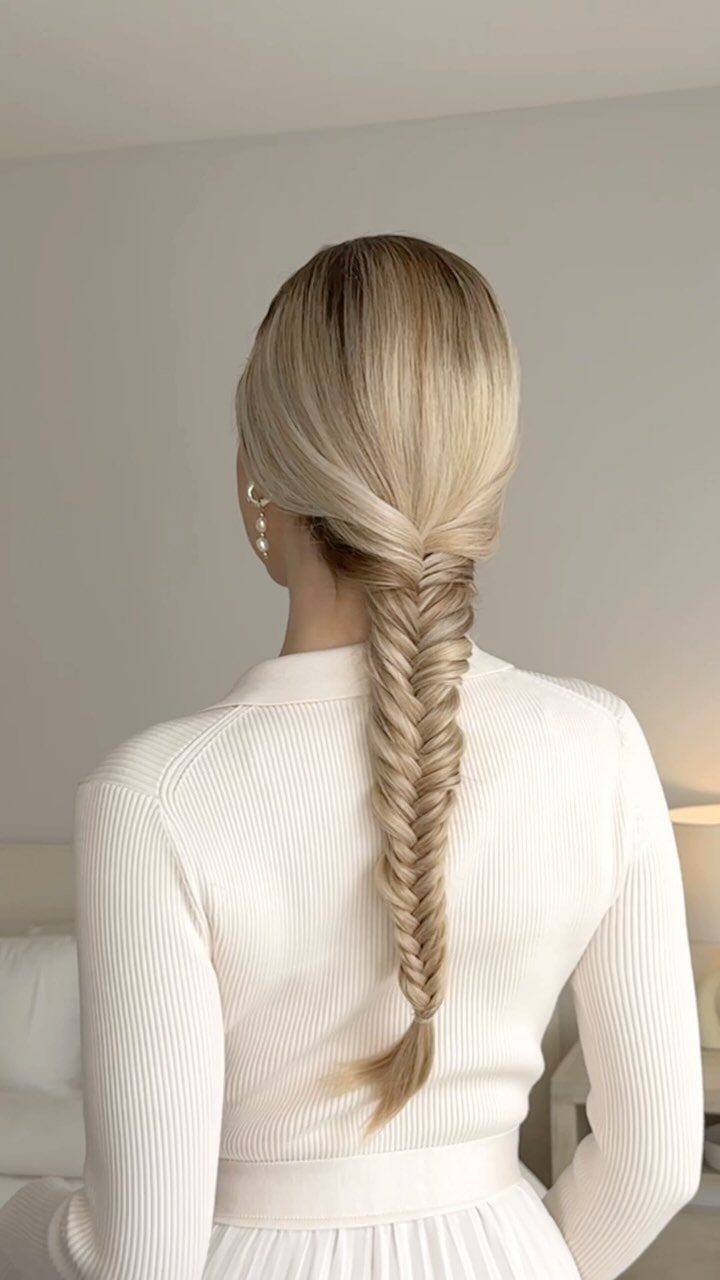 17 Cute Hairstyles for Picture Day, From Braids to Buns 8 Blonde hair styled in a long fishtail braid on a person wearing white.