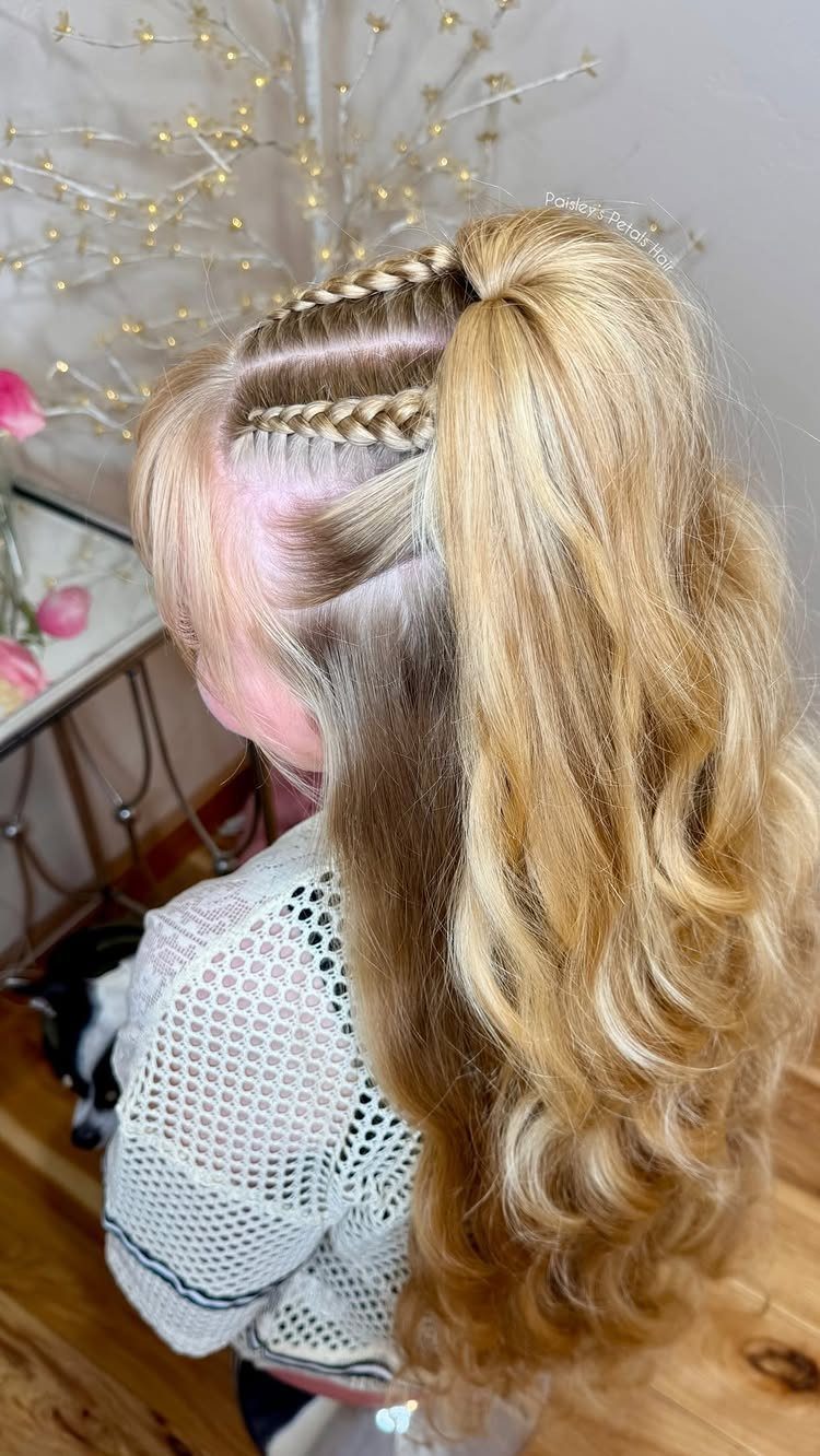 17 Cute Hairstyles for Picture Day, From Braids to Buns 11 Blonde wavy hair styled in a high ponytail with two small accent braids.