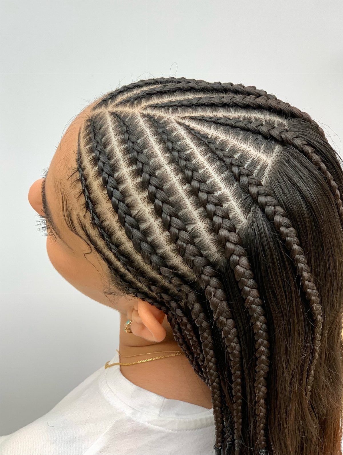 17 Cute Hairstyles for Picture Day, From Braids to Buns 13 Cornrow braids on a person's head, shown from a side profile view.