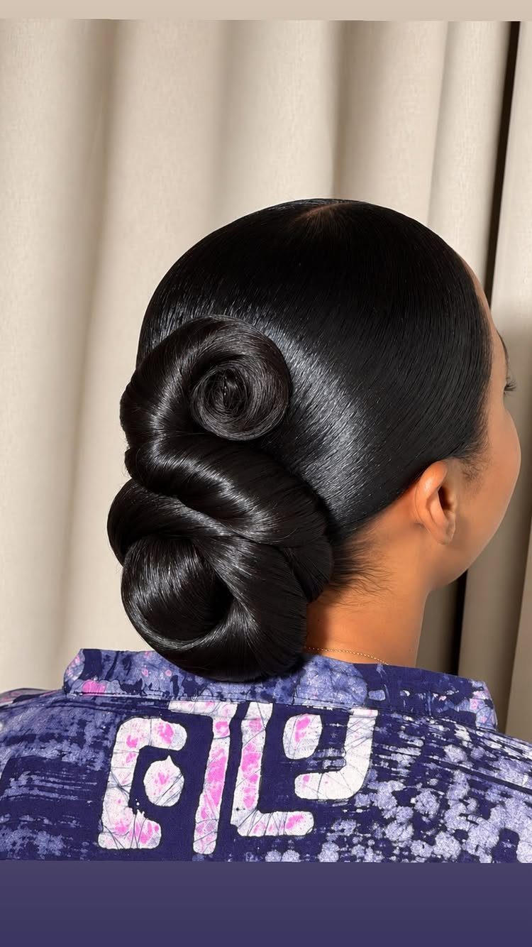 11 Cute Slick Backs: Braids, Buns, Ponytails and a Fade 6 Sculptural bun with glossy black hair styled in an artful, twisted knot.