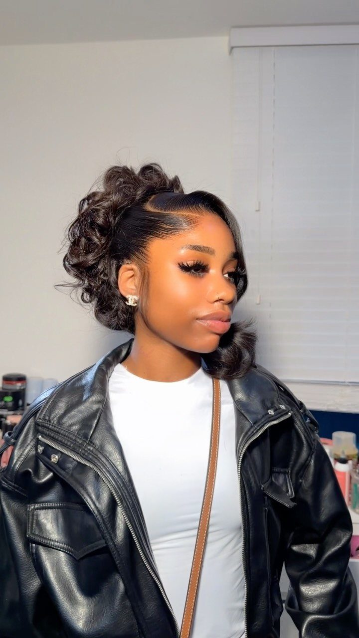 12 Cute Updo Hairstyles for Easy Everyday Styling 9 Woman with a high curly updo hairstyle wearing a black leather jacket.