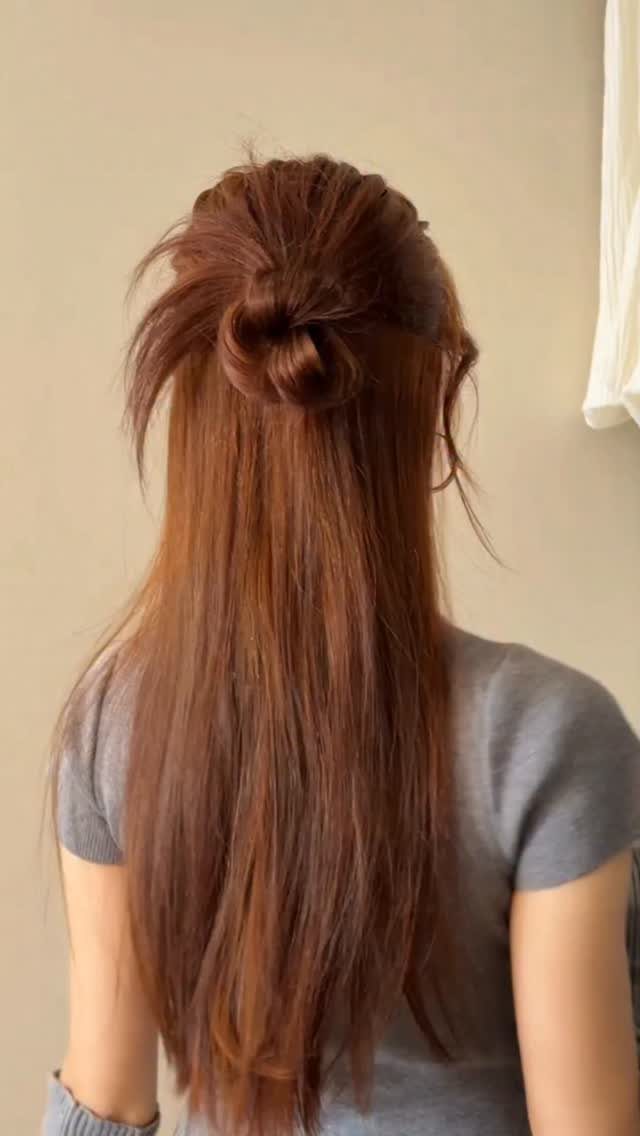 12 Cute Updo Hairstyles for Easy Everyday Styling 4 Reddish-brown hair styled in a half-up topknot with long straight hair flowing down.