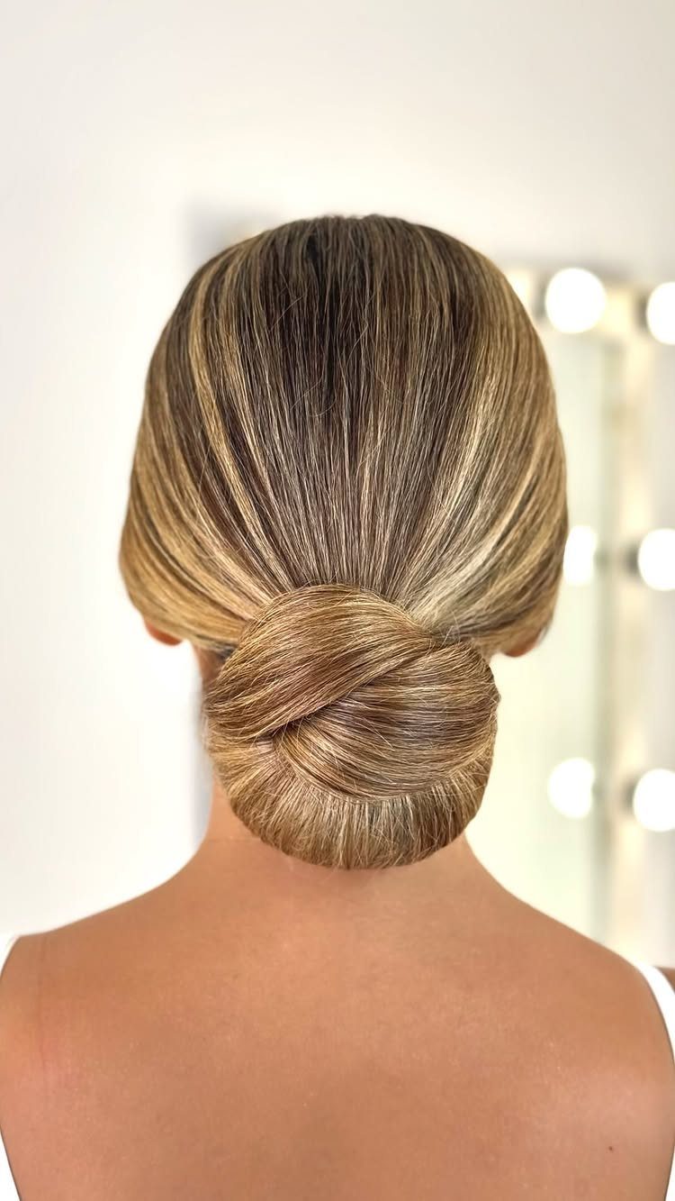 12 Cute Updo Hairstyles for Easy Everyday Styling 5 Sleek low bun with blonde highlights tied in a neat twisted knot.