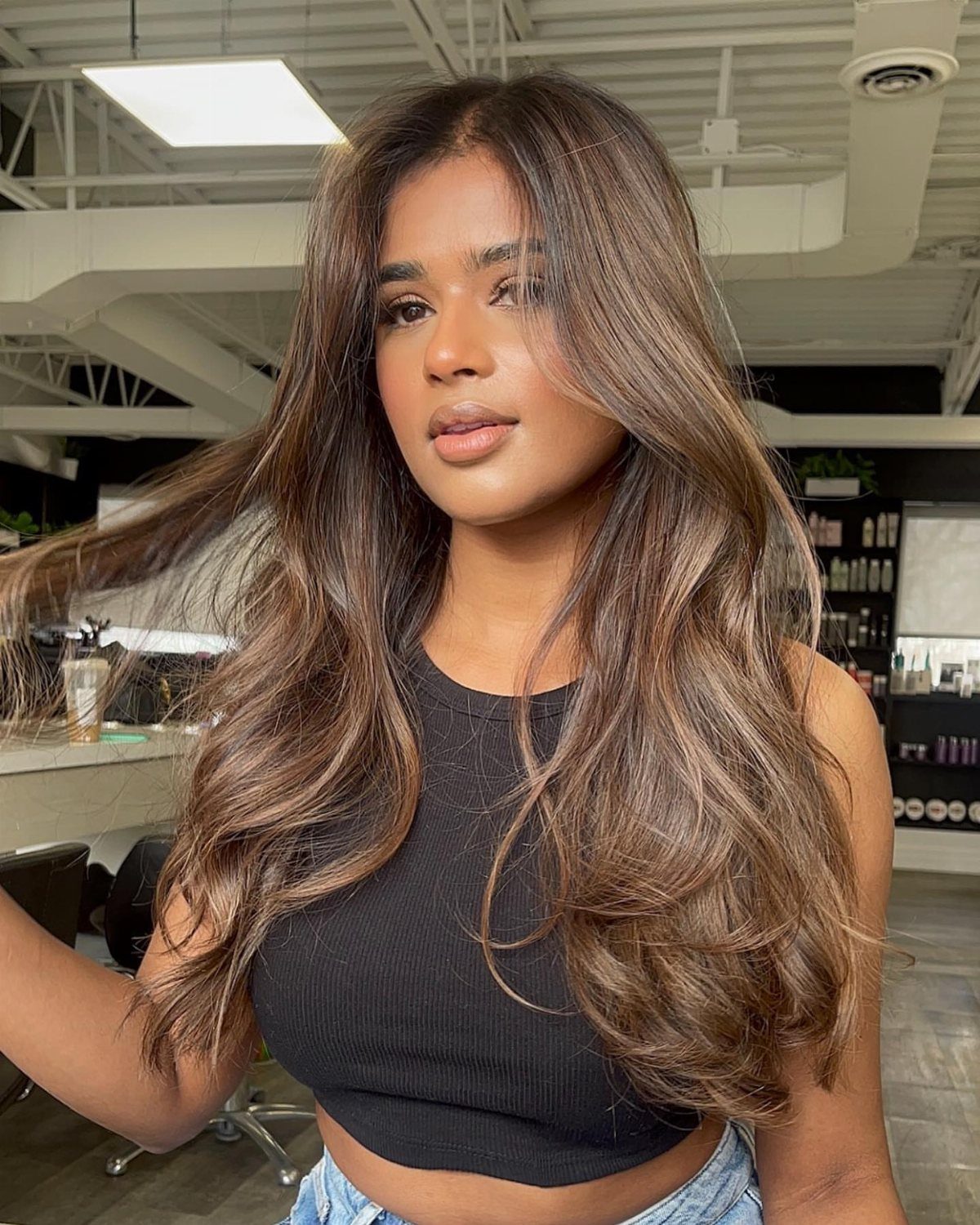 16 Dark Brunette Hair Color Ideas for Every Skin Tone 12 Woman with long wavy mocha brown hair and cool ashy brown highlights.