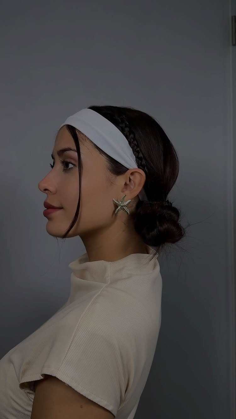 16 Easy Hair Styles for Beginners to Try at Home 1 Woman with dark hair in a low bun wearing a white headband and braid.
