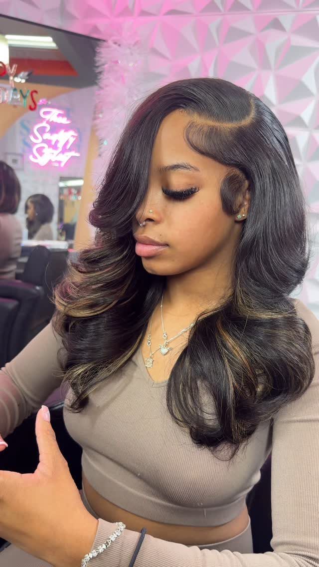 16 Easy Hair Styles for Beginners to Try at Home 7 Woman with long dark wavy hair styled in a deep side part