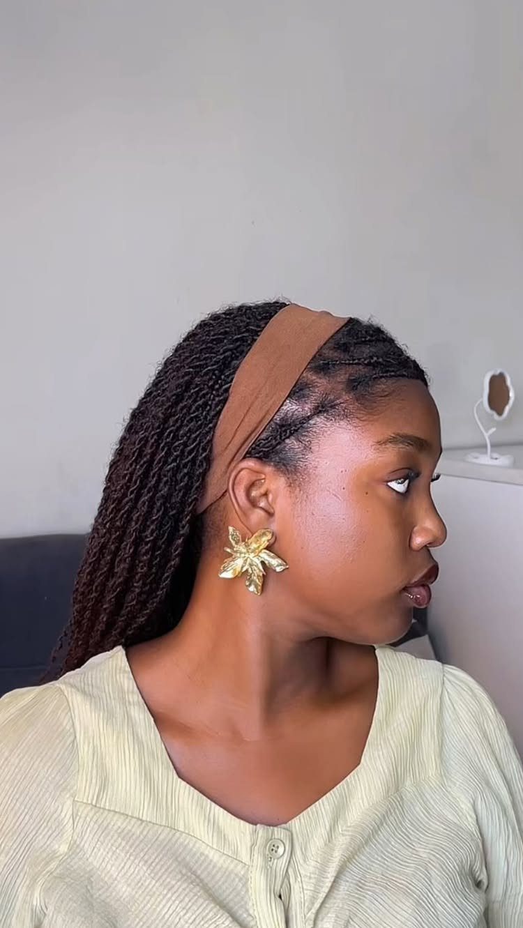 16 Easy Hair Styles for Beginners to Try at Home 4 Woman with dark twisted hair wearing a brown headband and gold flower earrings.