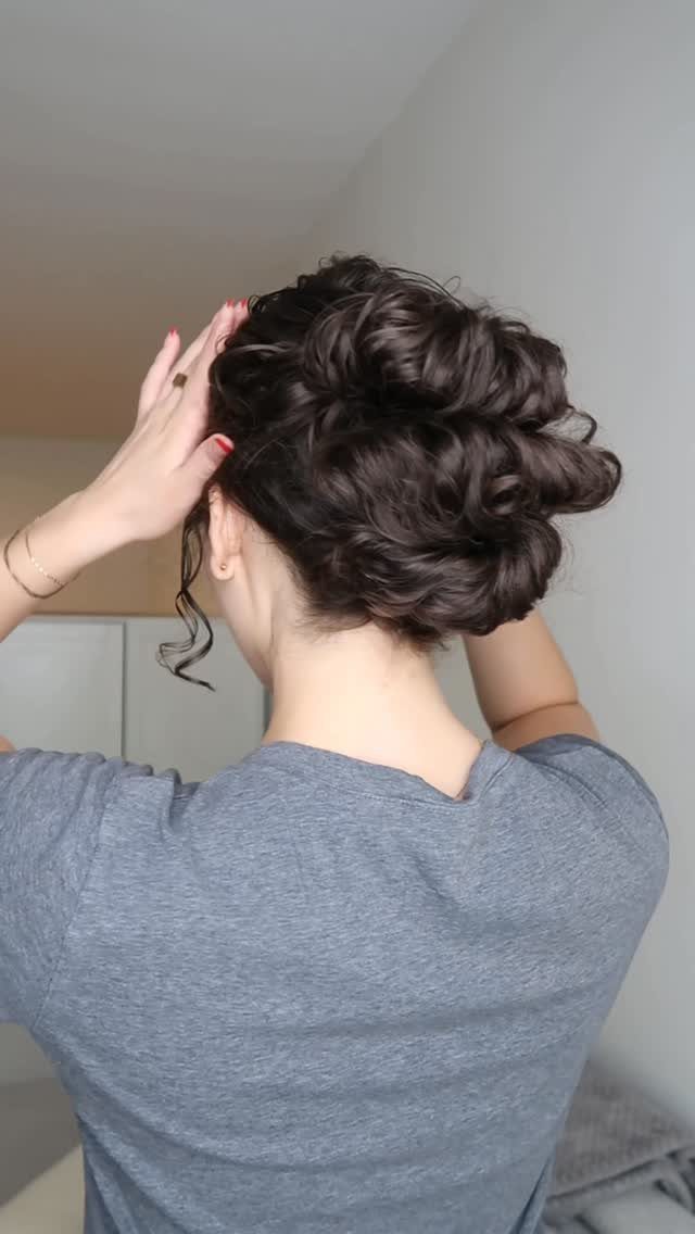 16 Easy Hair Styles for Beginners to Try at Home 10 Woman with dark curly hair styled in a voluminous textured updo from behind