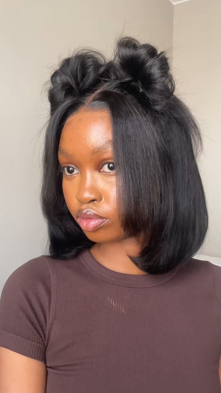 18 Easy Hairstyles for Medium Hair You Can Do Fast 17 Woman with medium black hair styled in a half-up bow hairstyle.