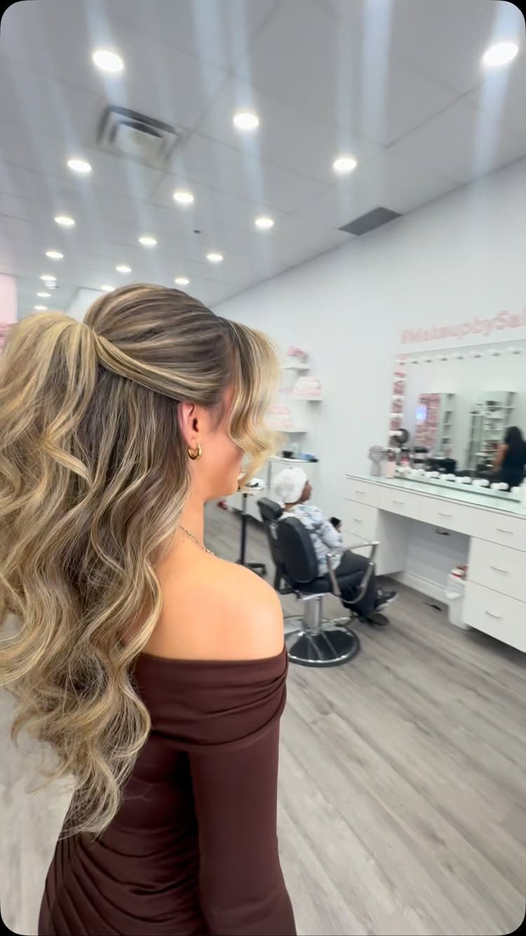 18 Easy Hairstyles for Medium Hair You Can Do Fast 13 Woman with blonde highlighted medium hair in a curly half-up ponytail hairstyle.