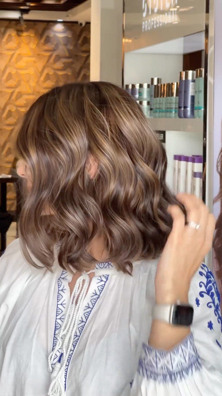 18 Easy Hairstyles for Medium Hair You Can Do Fast 8 Woman with medium-length brown hair styled in textured, tousled beachy waves.