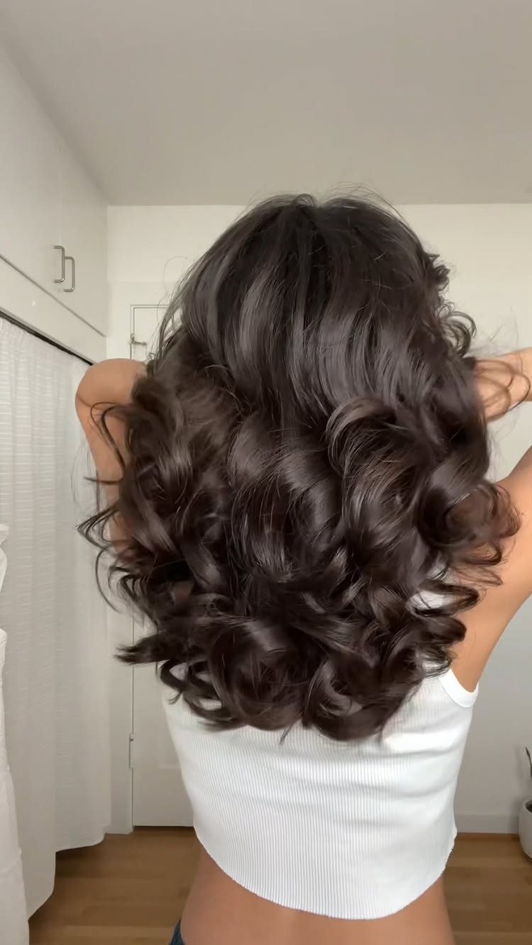 18 Easy Hairstyles for Medium Hair You Can Do Fast 18 Medium-length dark brown hair styled in voluminous, glossy curls from the back view.
