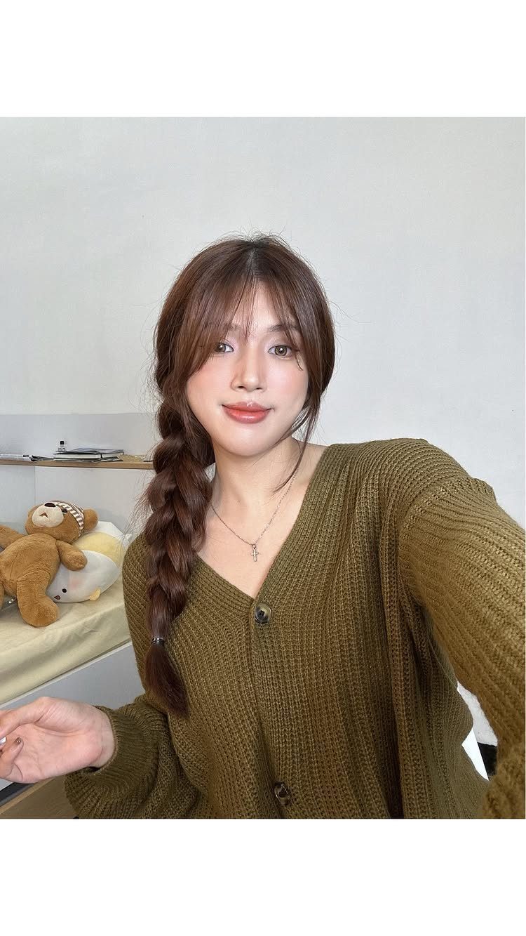 Easy One Braid Styles: 5 Ideas for Every Hair Type 5 Woman with brown hair styled in a single side braid wearing olive cardigan