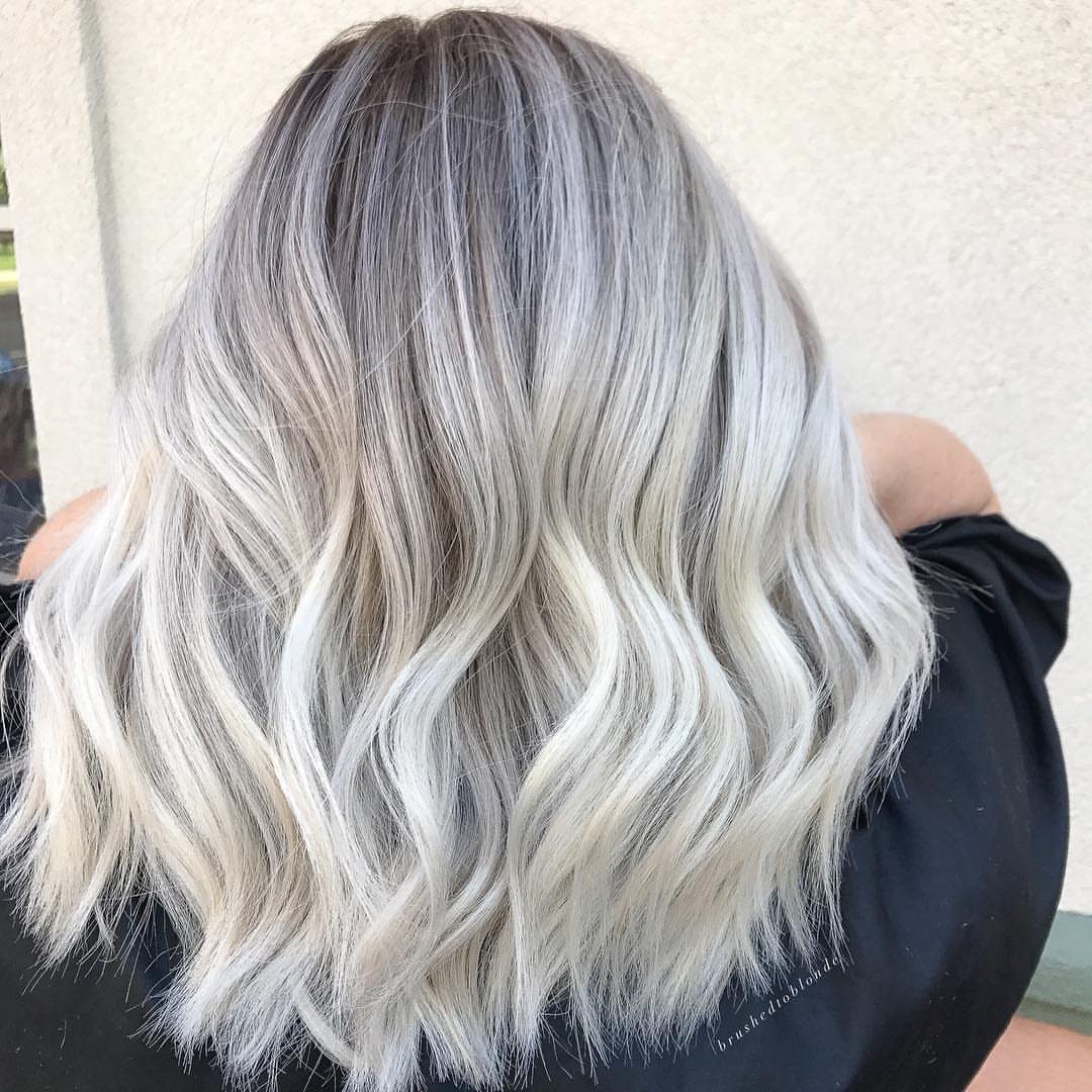 Fall Hair Dos with 15 Ideas from Burnt Copper to Claw Clips 10 Wavy silver-blonde hair with dark roots seen from the back.