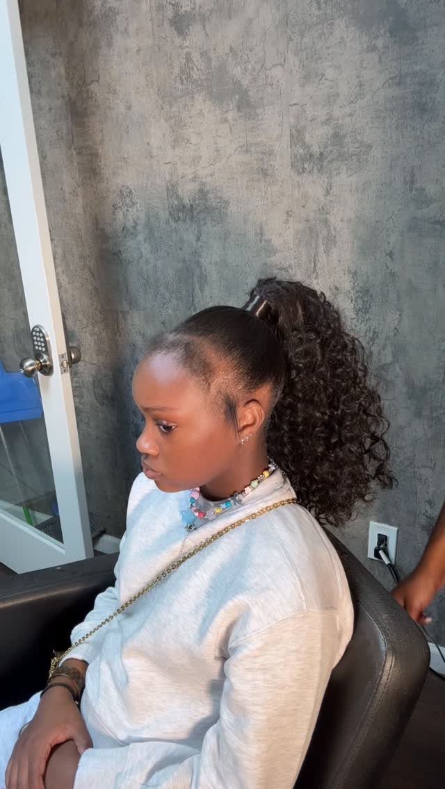 Fall Hair Dos with 15 Ideas from Burnt Copper to Claw Clips 1 Woman with a high sleek ponytail and curly hair wearing a white robe.