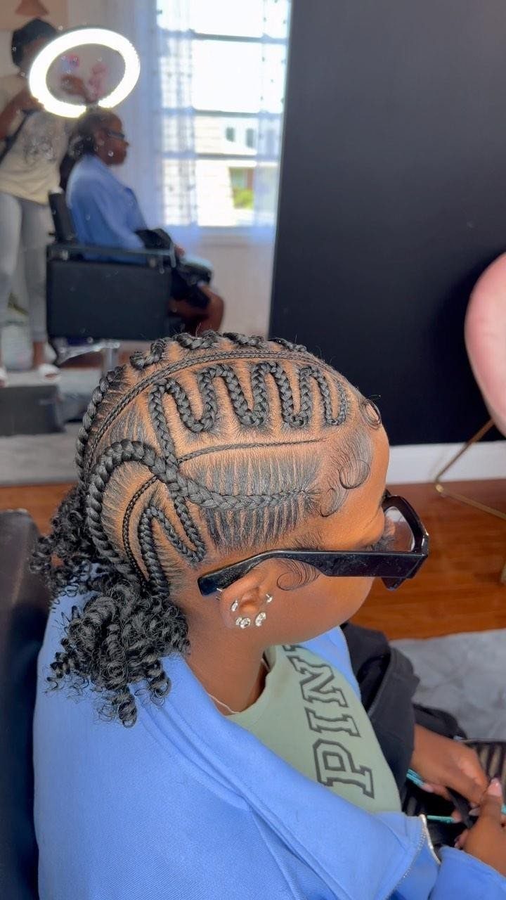 12 Good Hairstyles for Curly Hair, From Bangs to Braids 9 Person with intricate wavy cornrow braids and a curly ponytail at the nape.