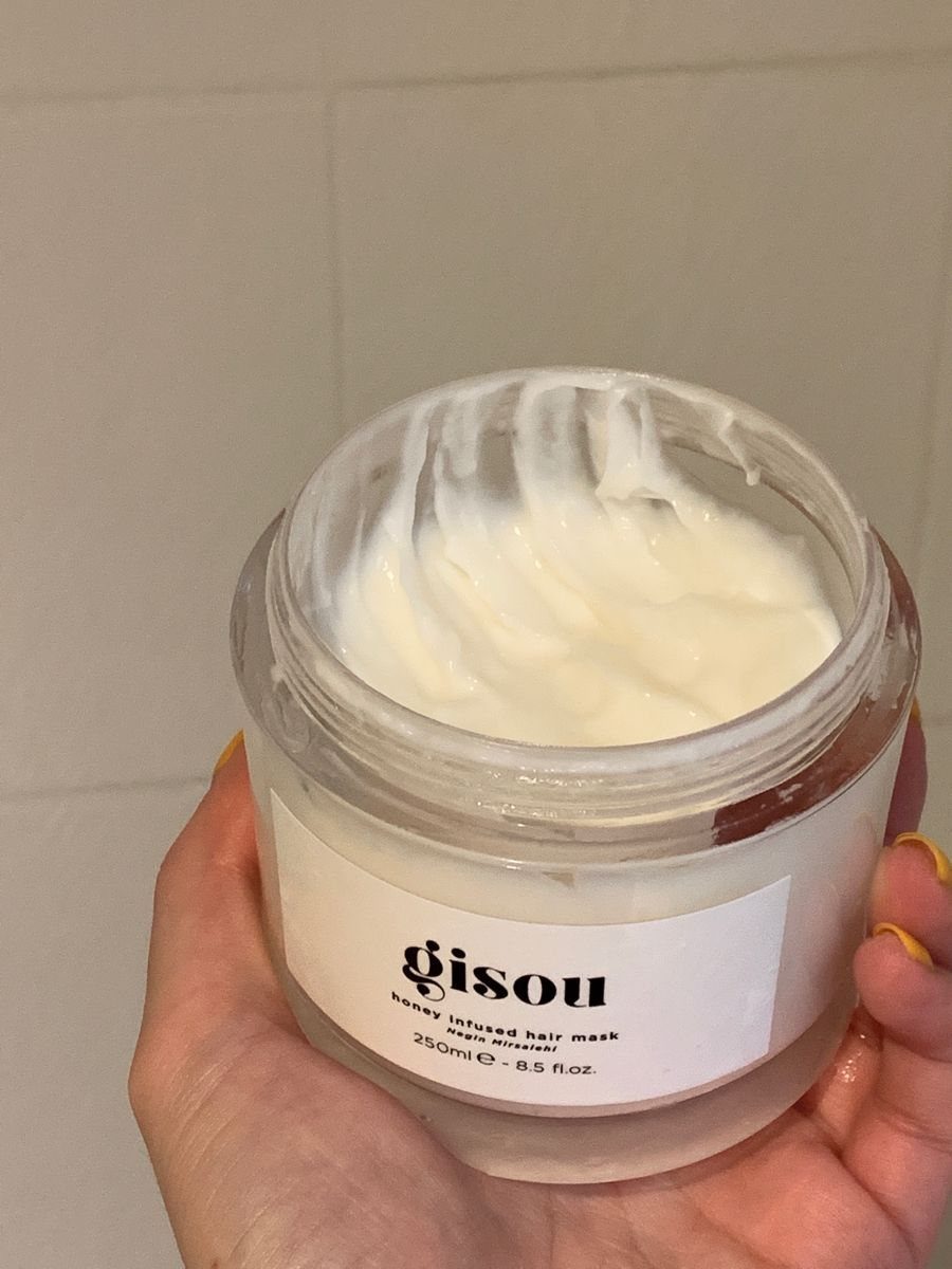 4 Ways to Grow Hair Fast: Scalp, Water, Silk and Masks 4 Gisou honey infused hair mask in an open clear jar held by hand