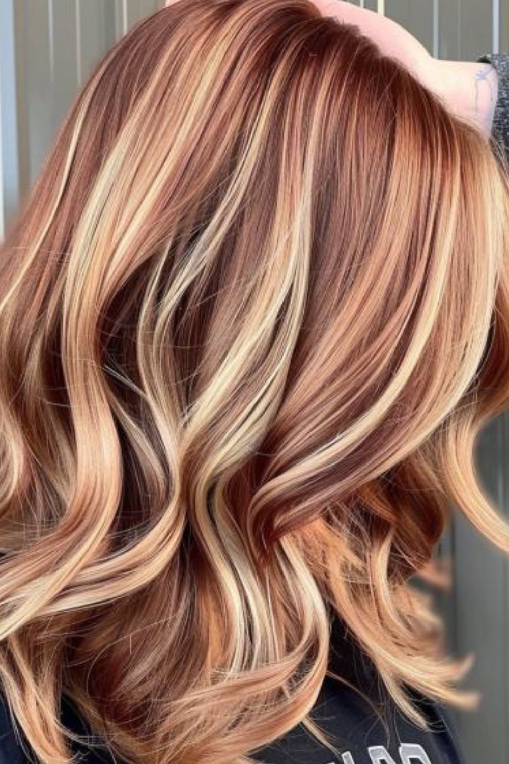 22 Hair Color Red and Blonde Ideas for Every Length 22 Long wavy auburn hair with bright blonde highlights styled in loose curls.