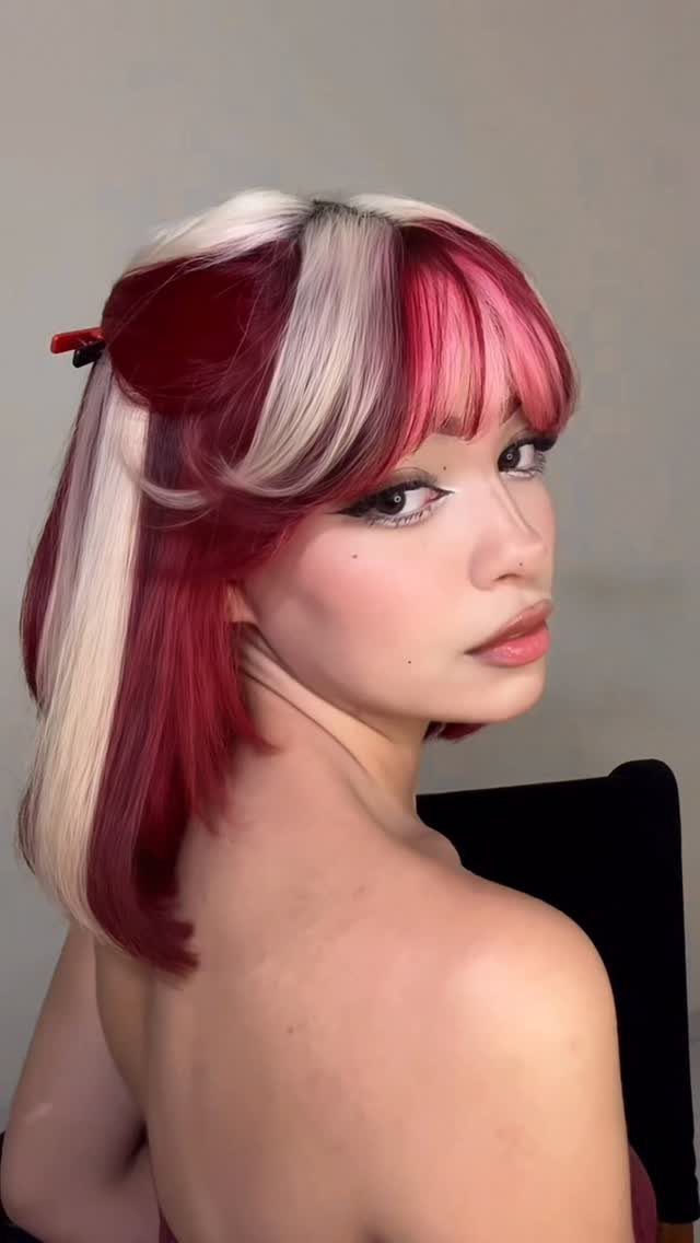 22 Hair Color Red and Blonde Ideas for Every Length 21 Woman with deep red hair and bold bleach blonde highlights and face-framing pieces.