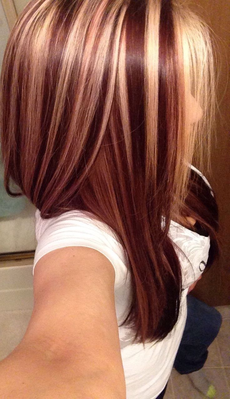 22 Hair Color Red and Blonde Ideas for Every Length 17 Long mahogany red hair with bright blonde highlights seen from a side profile.