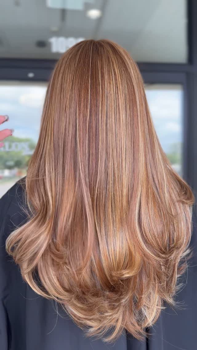 22 Hair Color Red and Blonde Ideas for Every Length 10 Long wavy copper red hair with light blonde highlights and layered ends.