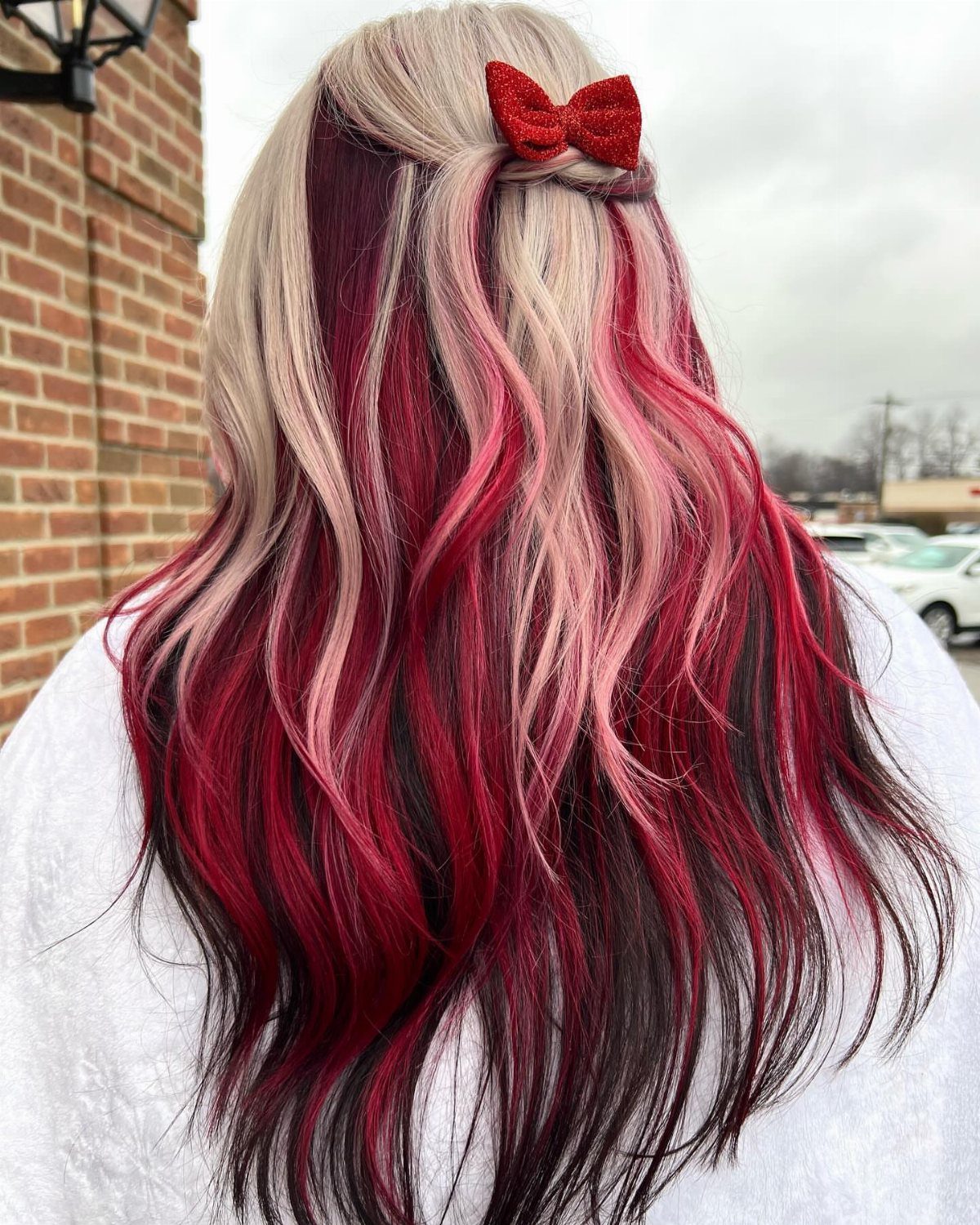 22 Hair Color Red and Blonde Ideas for Every Length 6 Long wavy hair with deep red and platinum blonde highlights and red bow