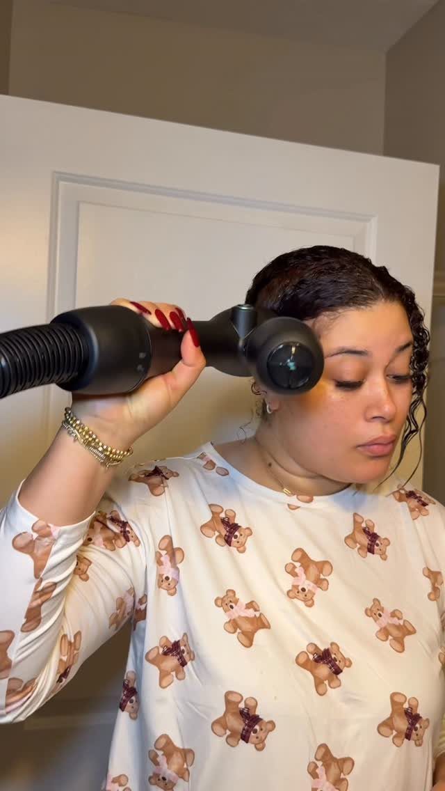 3 Hair Dryers for Natural Hair: Handheld, Diffuser, Brush 3 Woman using a black hair dryer brush on her natural dark hair.