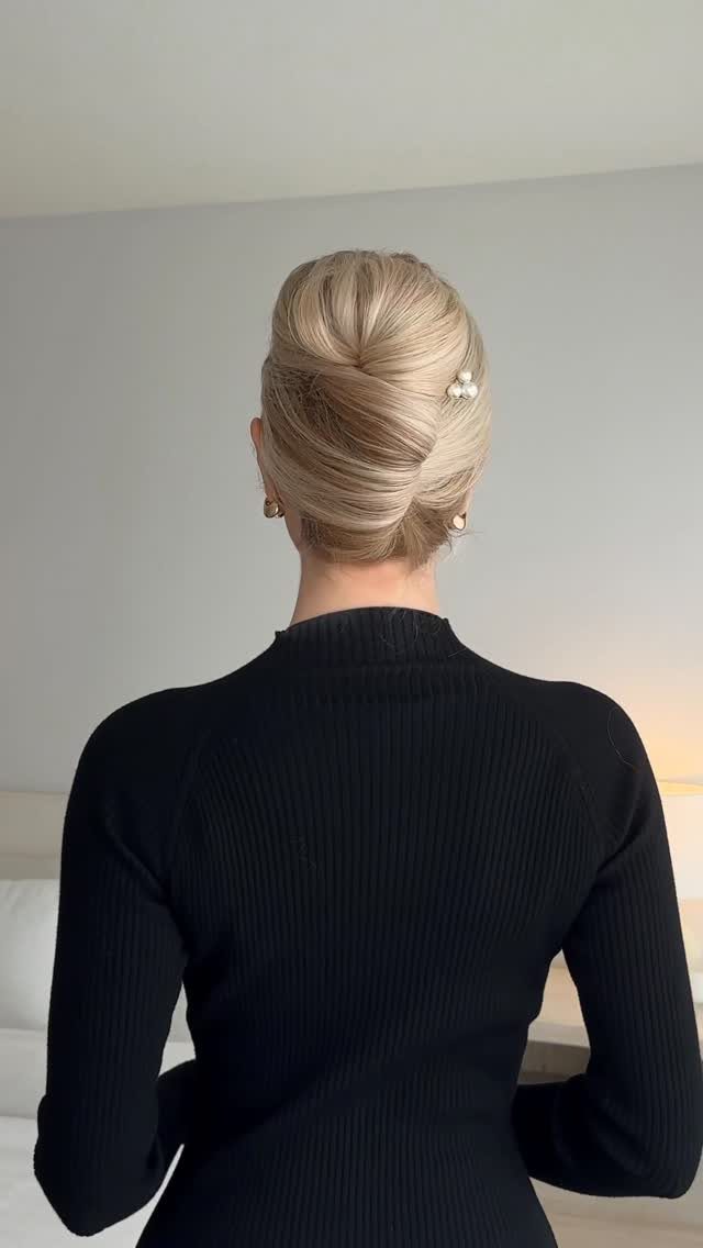 15 Ways to Pick a Hairstyle for Sweater Weather 9 Blonde hair styled in a French roll with a pearl clip and black sweater