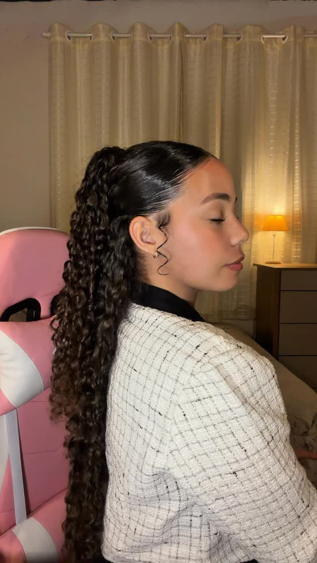 15 Ways to Pick a Hairstyle for Sweater Weather 3 Woman with long curly hair tied in a high ponytail wearing a checkered blazer