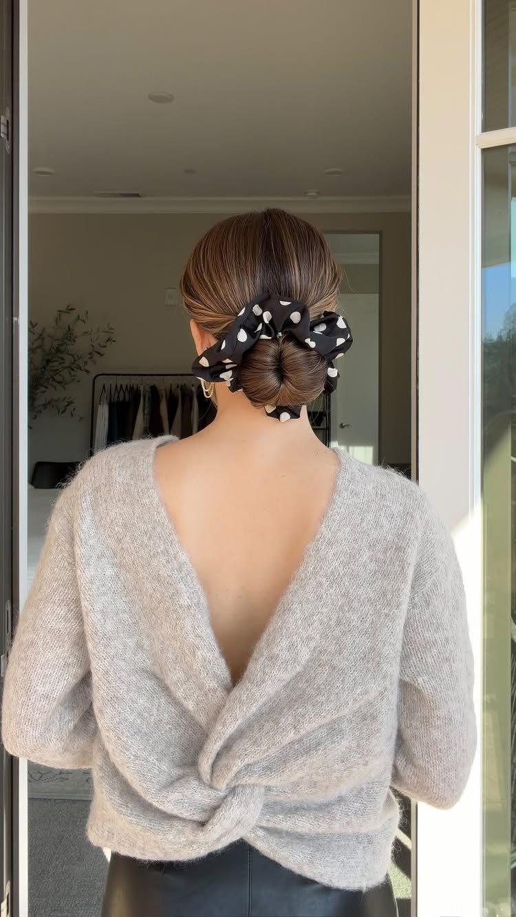 15 Ways to Pick a Hairstyle for Sweater Weather 12 Woman from behind with a low bun and polka dot scrunchie wearing grey sweater
