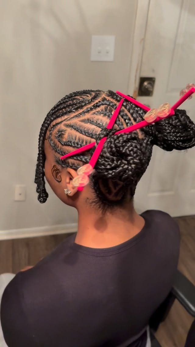 17 Hairstyles for Football Games: Braids, Buns & Ponytails 16 Intricate cornrow braids with pink ribbons and ties on a person's head.