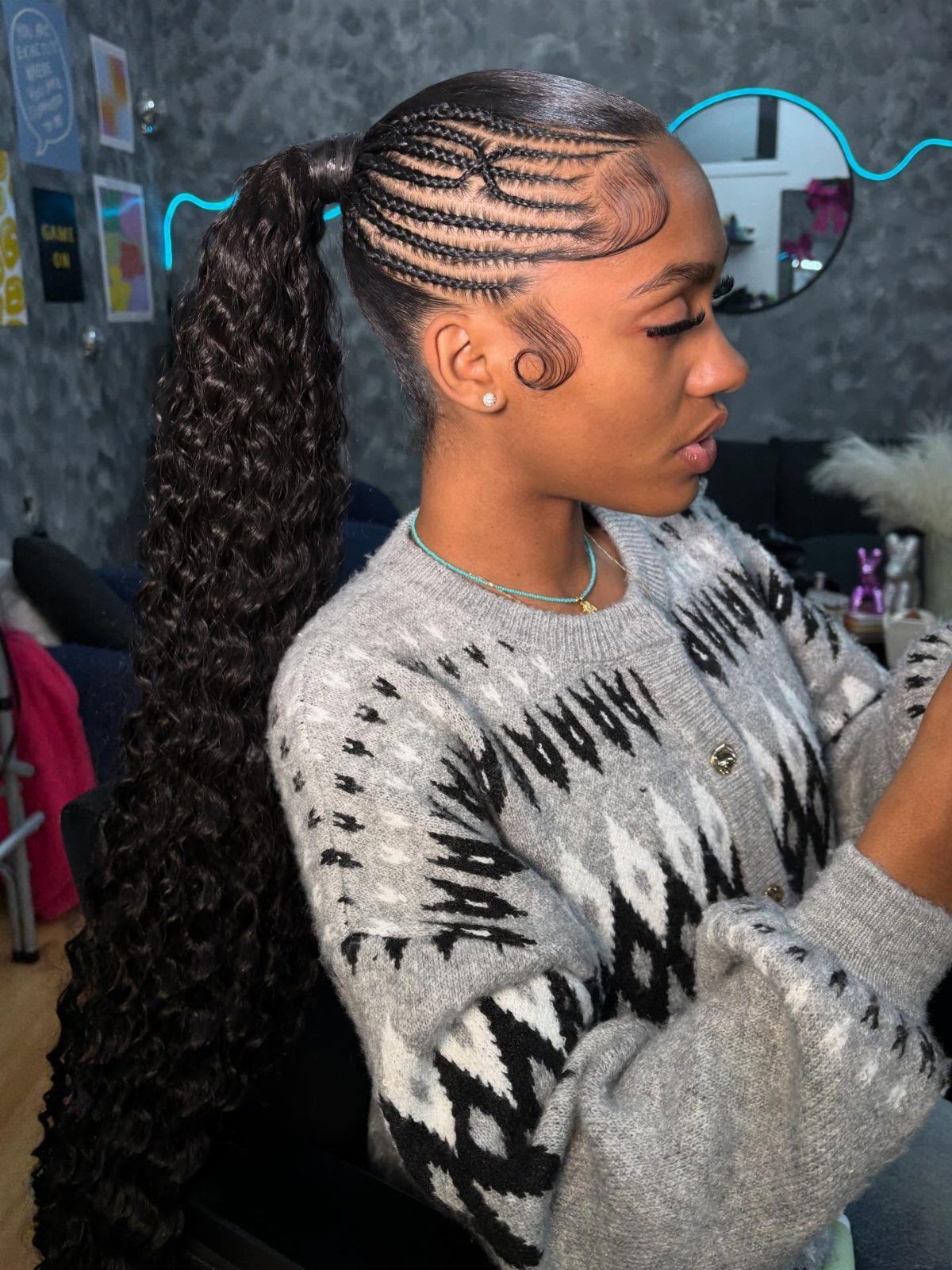 17 Hairstyles for Football Games: Braids, Buns & Ponytails 5 Woman with a high curly ponytail and small cornrow braids on the sides.