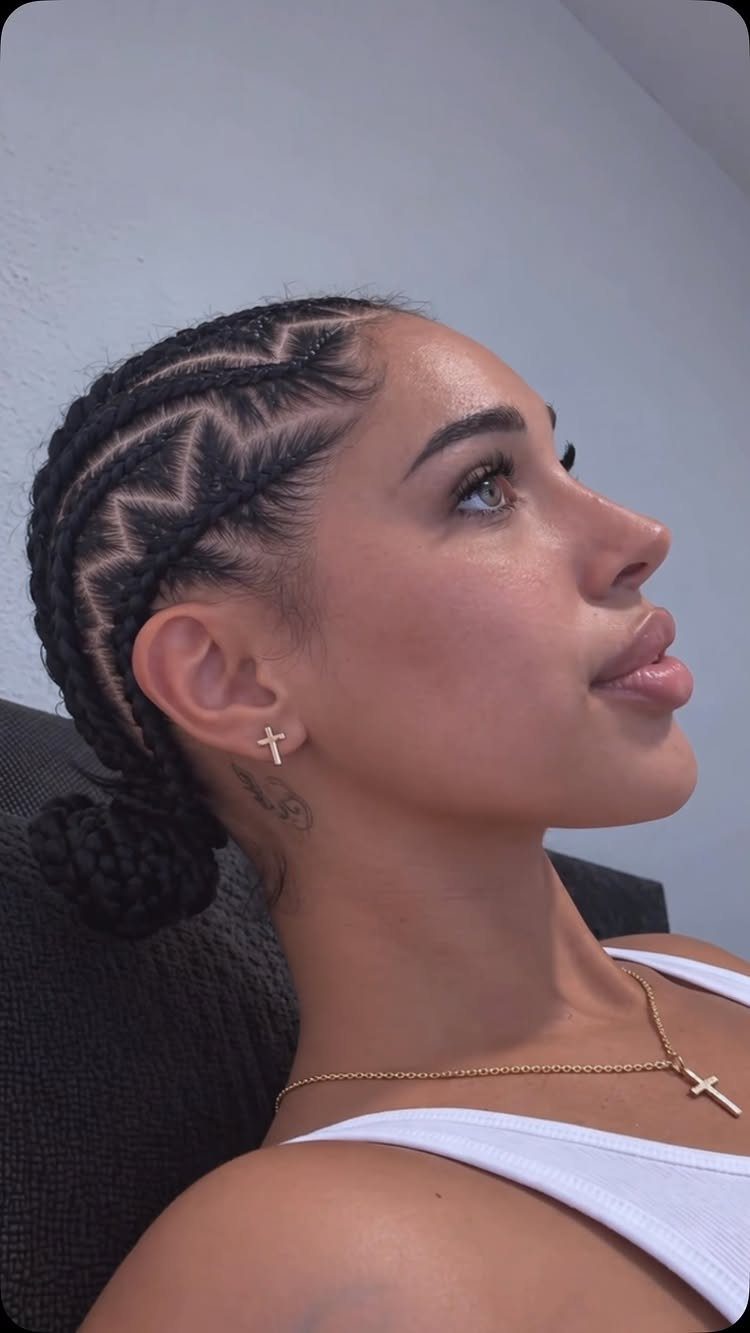 17 Hairstyles for Football Games: Braids, Buns & Ponytails 6 Woman with zig-zag patterned cornrow braids gathered into a low hair bun.