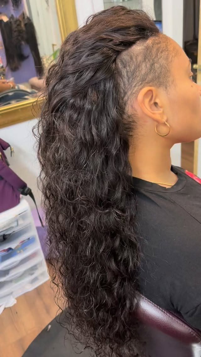 Person with long wavy dark hair and a shaved disconnected undercut side profile