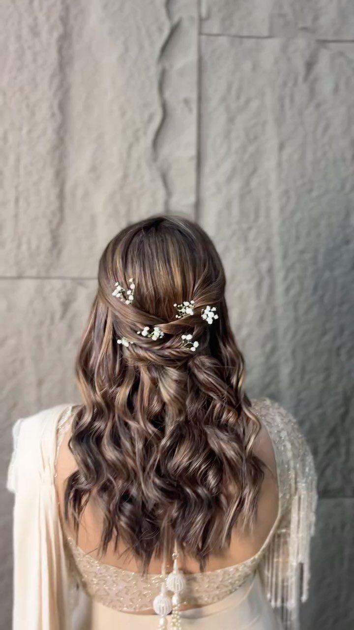 10 Hairstyles on Saree for Every Look and Occasion 9 Wavy brown hair in a half-up style with floral pins and cream saree.