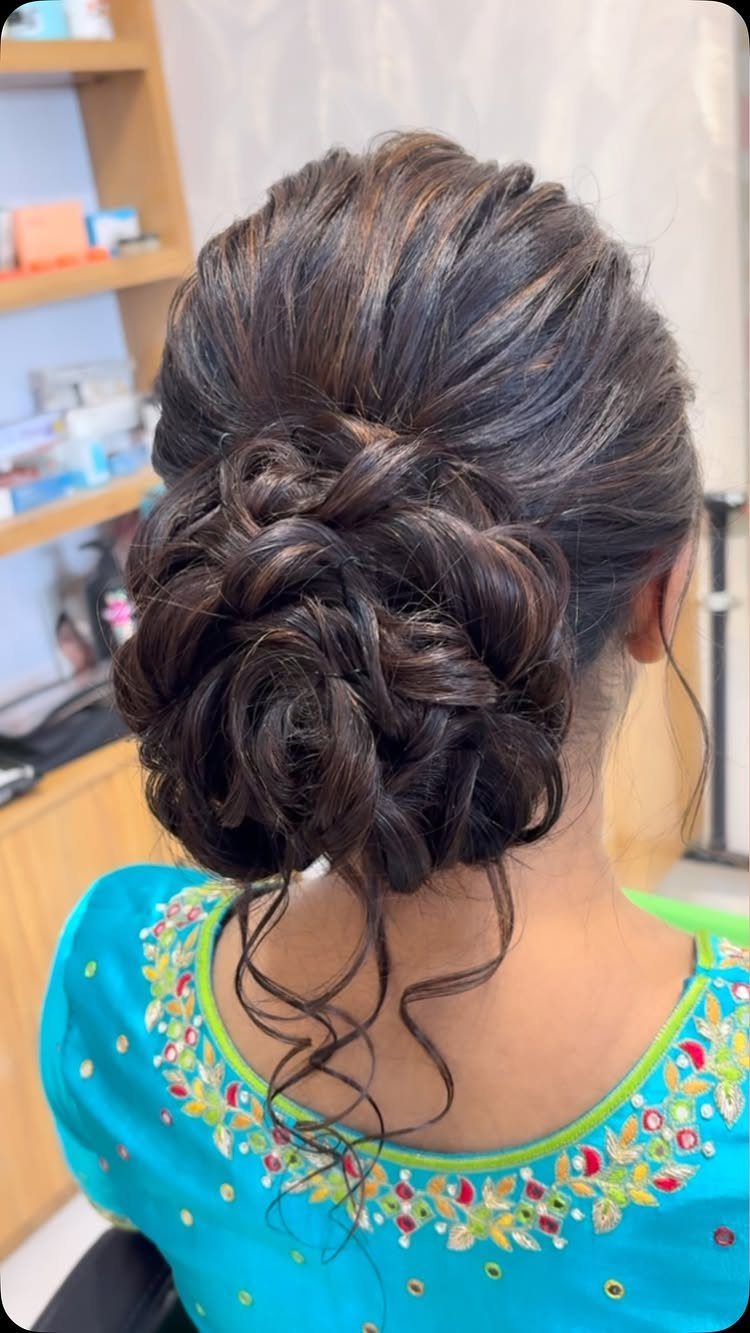 10 Hairstyles on Saree for Every Look and Occasion 4 Textured low messy bun with loose curls on a person in blue blouse