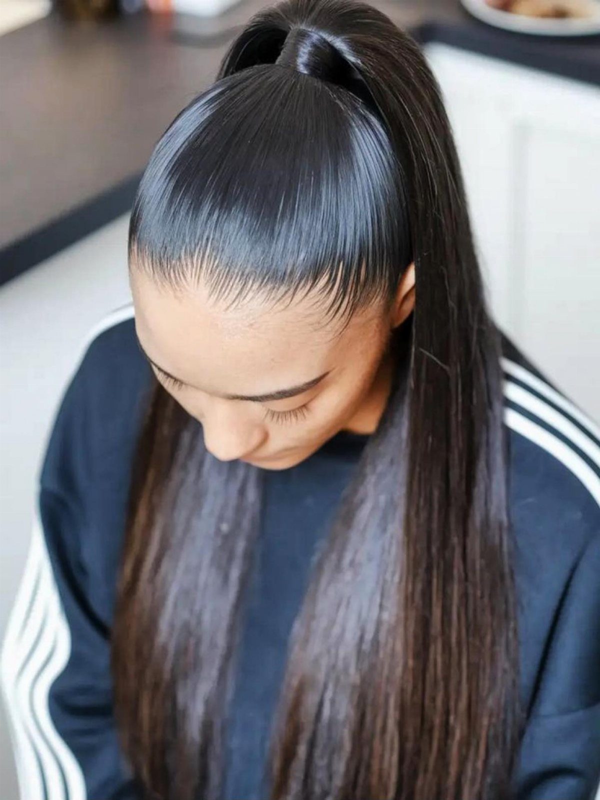 22 Hairstyles for Real Hair, from Bantu Knots to Bobs 15 Woman with long straight black hair styled in a high slicked-back ponytail