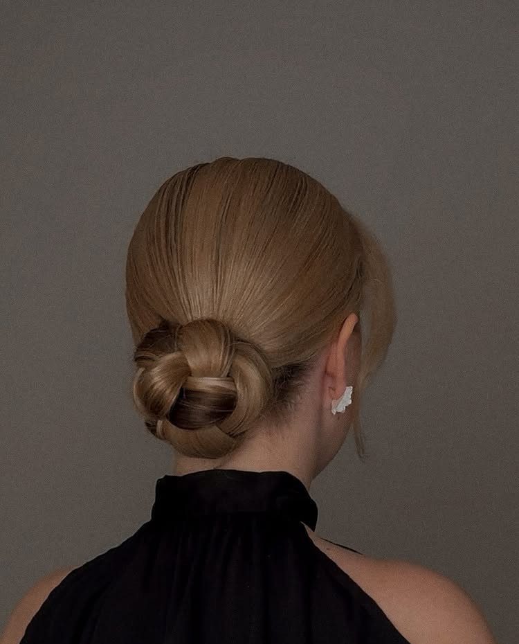 22 Hairstyles for Real Hair, from Bantu Knots to Bobs 6 Blonde hair styled into a sleek low bun at the nape of the neck.