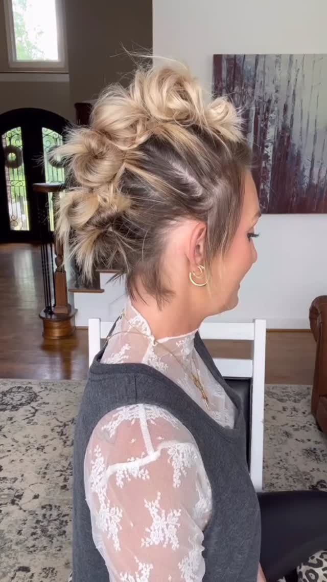 22 Hairstyles for Real Hair, from Bantu Knots to Bobs 21 Woman with blonde highlighted hair styled in a textured, voluminous updo profile view