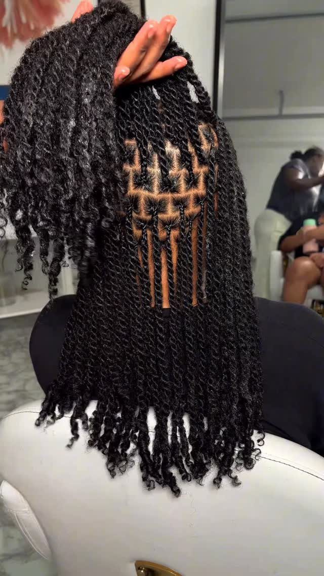 23 Hairstyles with Black Hair: Braids, Cuts, and Buns 8 Long black twisted hair with a grid-patterned scalp and curly ends.