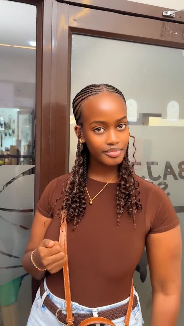Half Braid Half Curly Hairstyles: 5 Ideas to Try 3 Woman with cornrows on top and loose curly braids hanging down her shoulders.