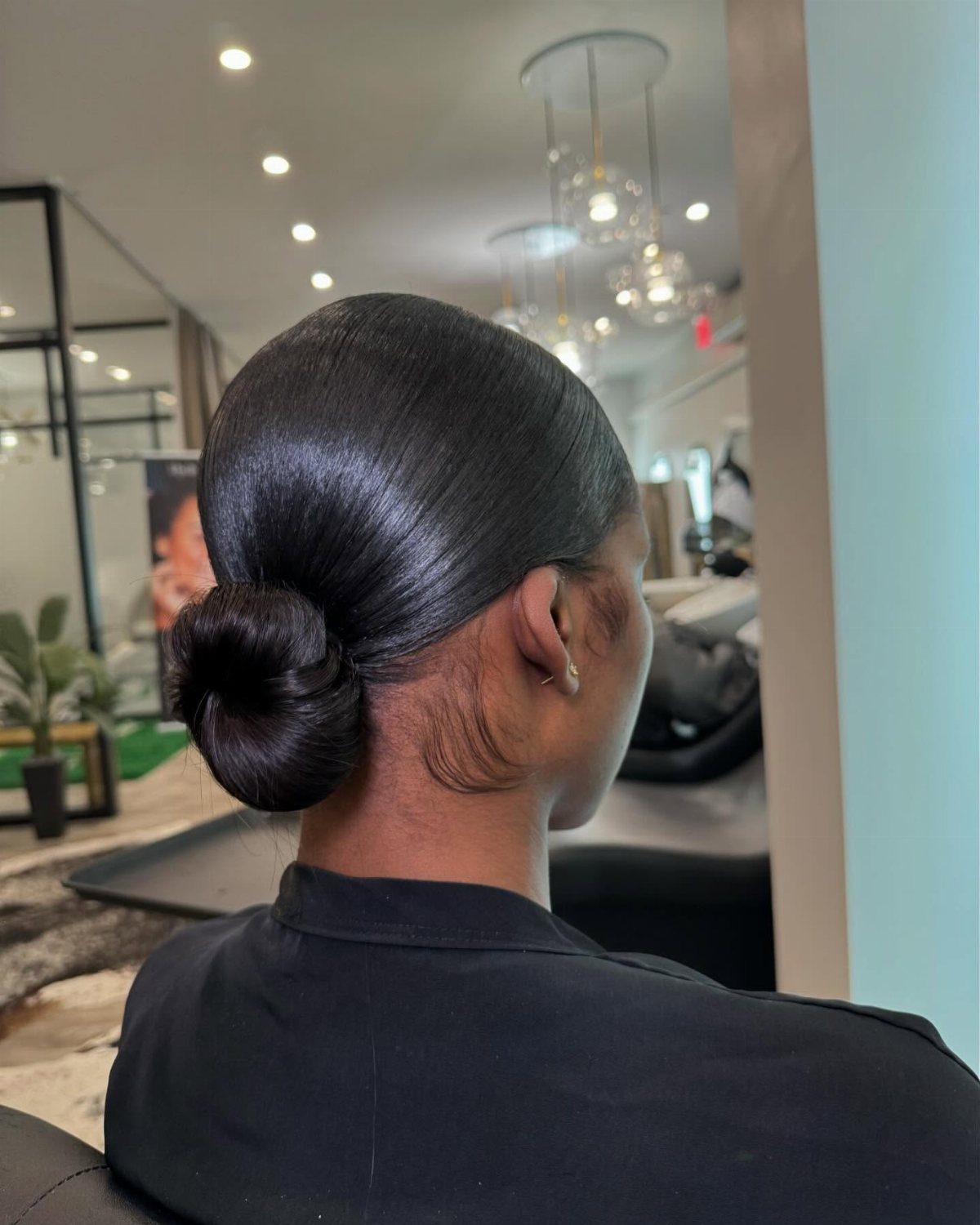 Healthy Hair Styles: 17 Protective Ideas for Natural Hair 1 Woman with sleek dark hair styled into a smooth, tight low bun.