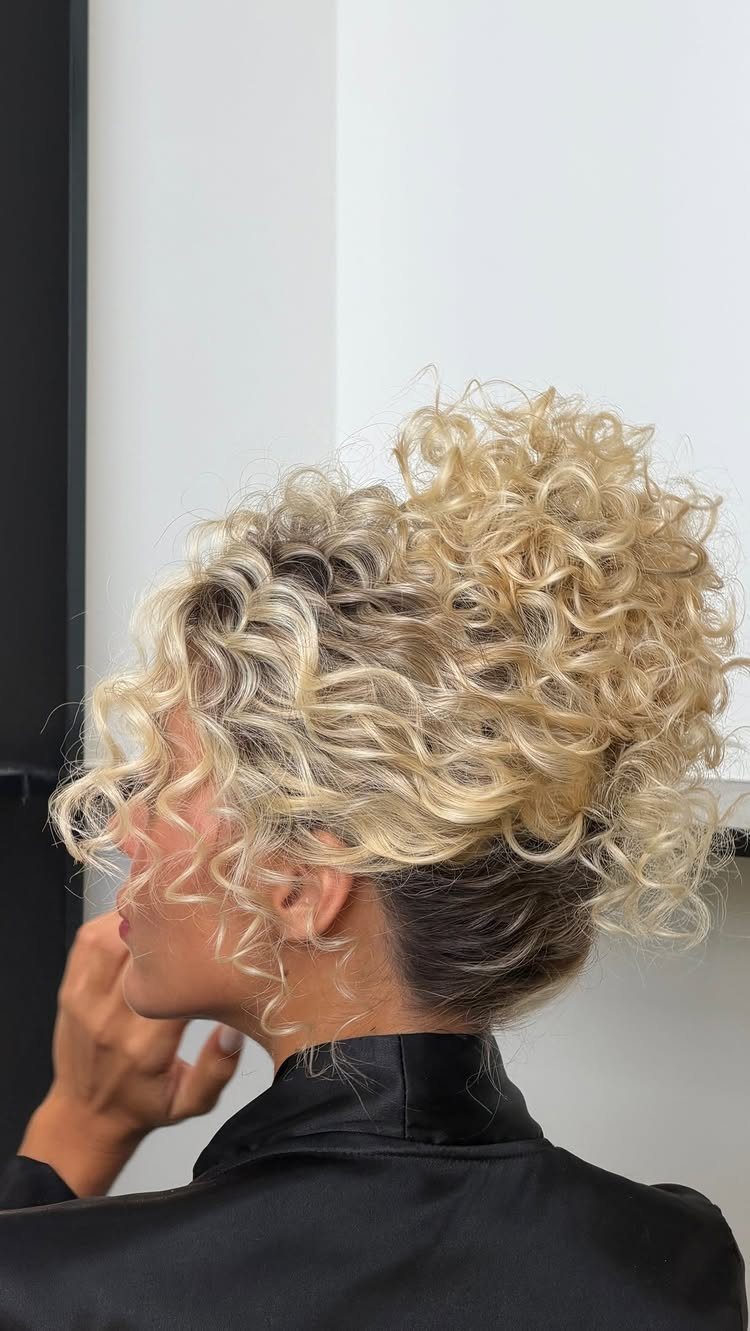16 Homecoming Hair Curly Ideas: Buns, Braids, and Puffs 7 Blonde curly hair styled into a voluminous high chignon with defined curls.