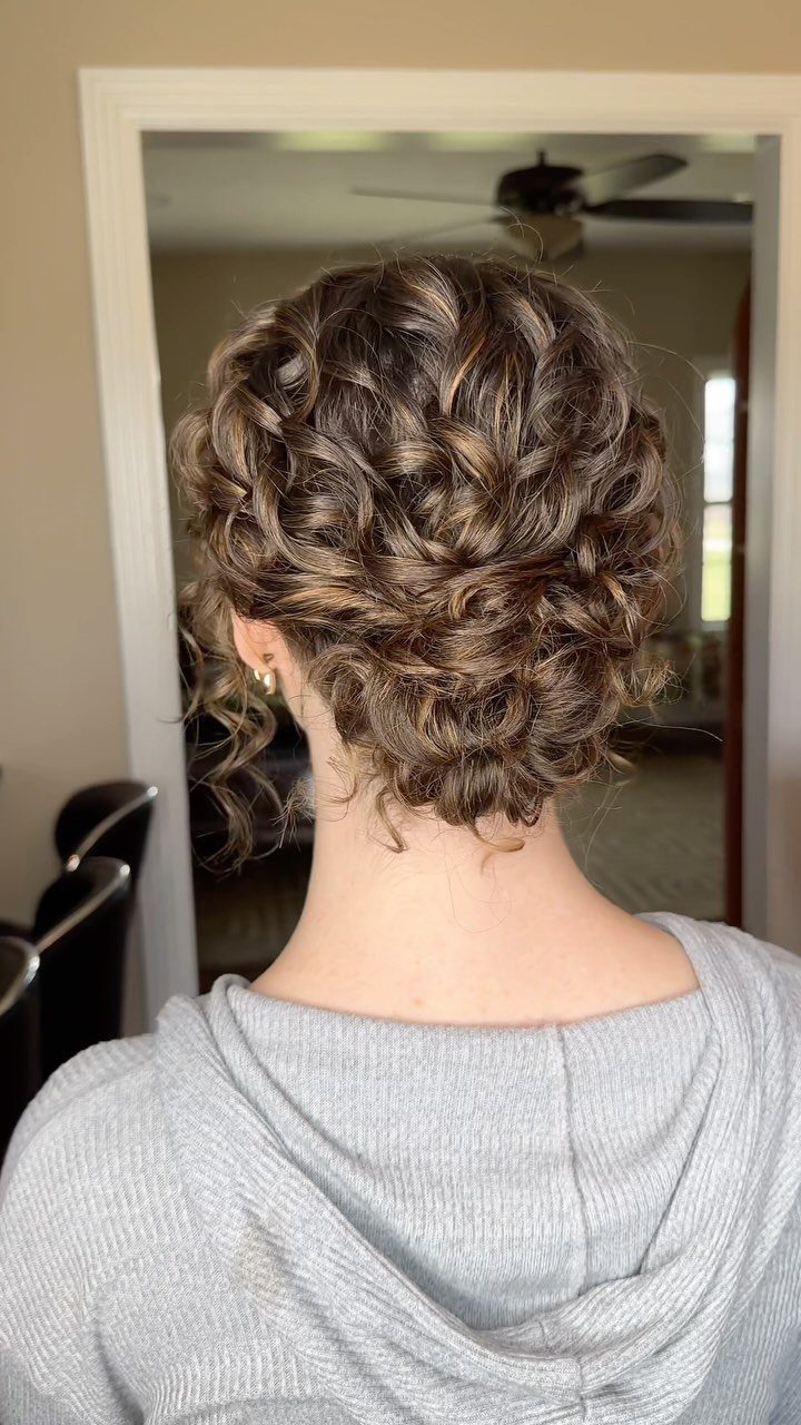 16 Homecoming Hair Curly Ideas: Buns, Braids, and Puffs 8 Short curly brown hair styled into a textured updo from the back view.