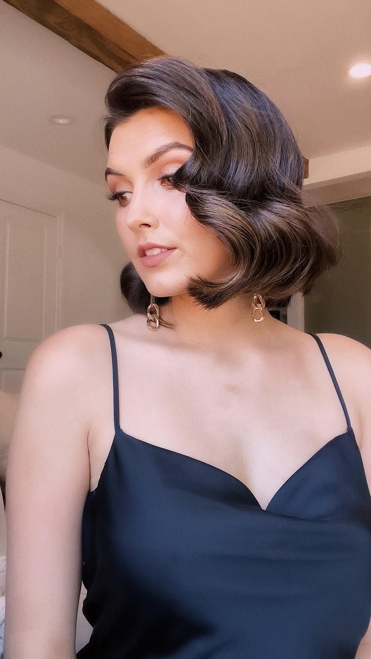 16 Homecoming Hair Curly Ideas: Buns, Braids, and Puffs 12 Woman with dark brown vintage waves wearing a black satin slip dress.