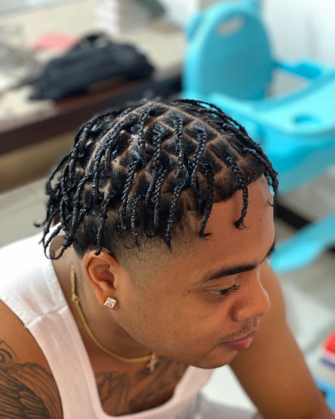 6 Knotless Braids Men Can Wear: Styles With Fades and Color 2 Man with black knotless box braids and a clean fade haircut.